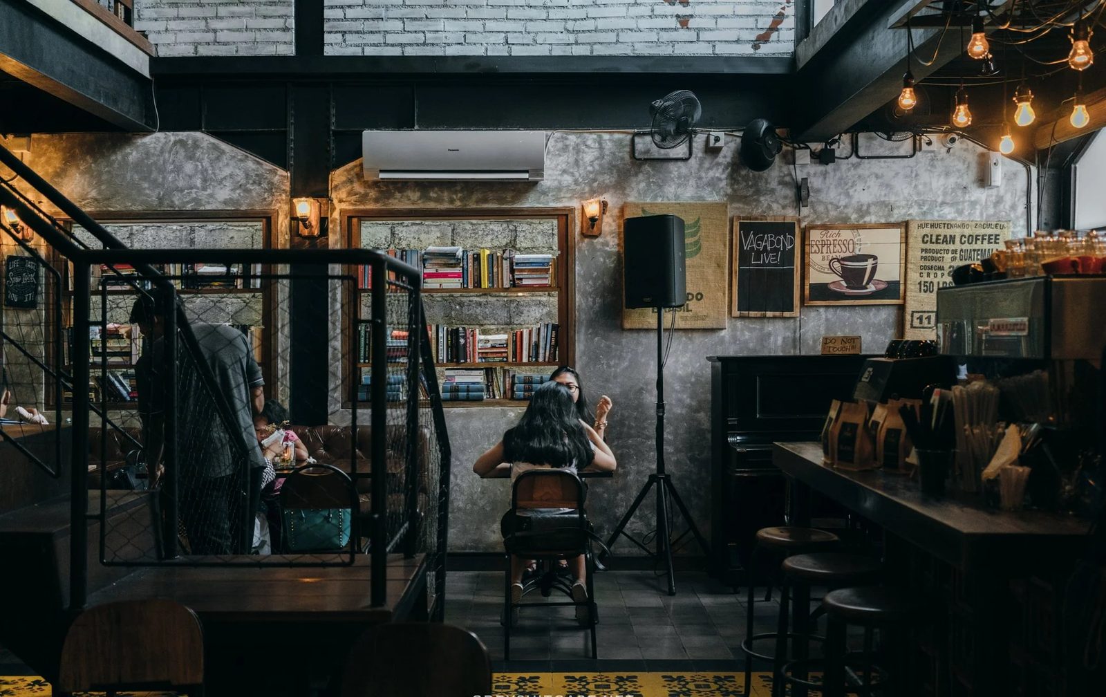 The back stage at Pison — Edison bulbs, mic stand, encaustic tile